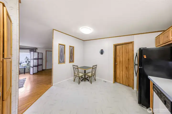 Wide-angle kitchen view highlighting  storage, workspace, and connection to the  living area