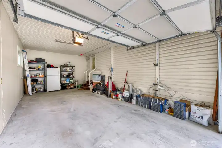Oversized garage with built-in shelving and  ample space for storage or hobbies