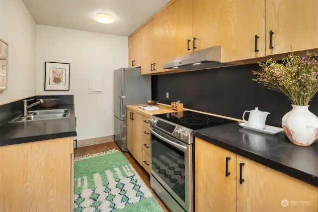 Updated kitchen with butcher block countertops and additional cabinets for more storage.