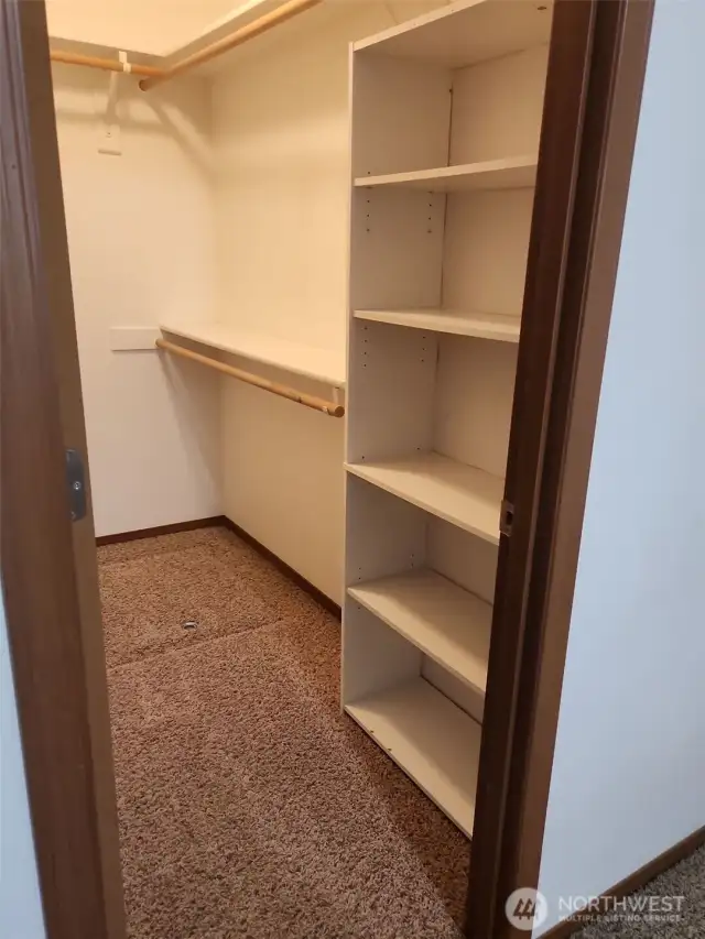 Spacious primary walk-in closet.