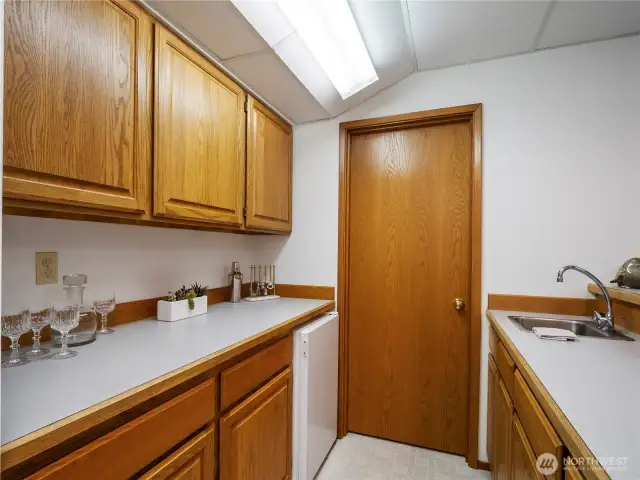 The wet bar has walk-in storage that can serve many purposes.