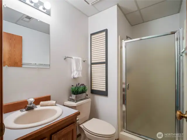 The downstairs bathroom is conveniently located between the two bedrooms ad offers a walk-in shower.