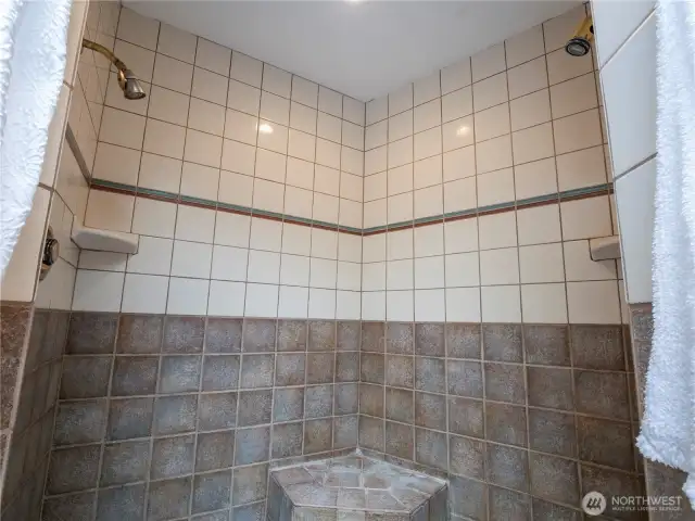 The primary shower is tiled and have a seat to take a rest when you enjoy your shower.
