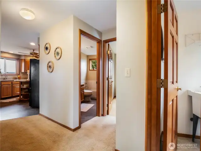 Hallway between the upstairs full guest bathroom, bedroom and laundry room