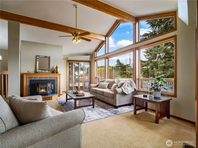 A cozy fireplace gives the living room ambiance and the easy access out to the oversized deck makes this a dream entertainment home.
