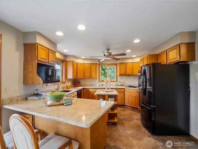 The kitchen has granite countertops and warm colored oak cabinets. It is classic and doing the dishes is a breeze with the view of the mountains.