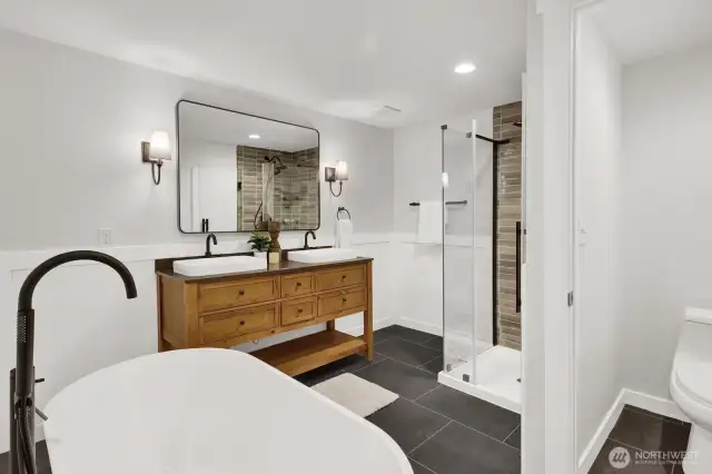 The primary bath is a spa retreat with high-end tile, walk-in shower, soaker tub, private toilet, and lots of space