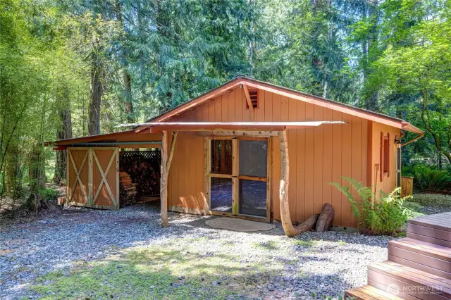 The outbuilding offers an large shop with electric and water as well as a large garage/woodshed/workshop.