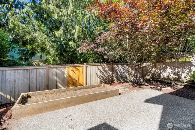 Fully fenced yard with garden beds