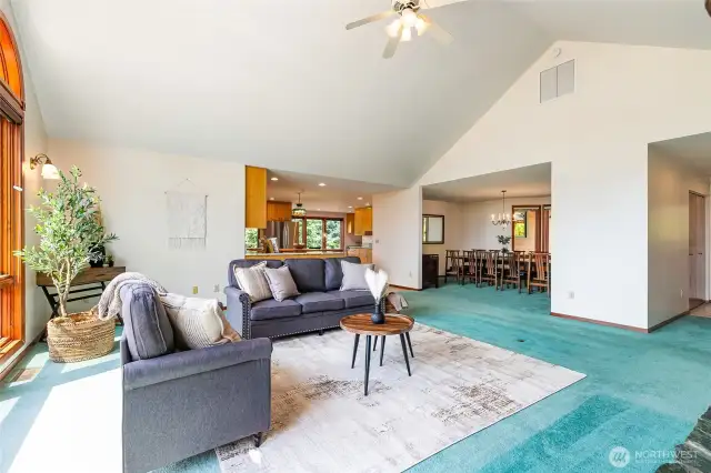 Large open living room looking into the kitchen and dinning room