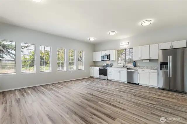 looking from the door into the room with a full kitchen.