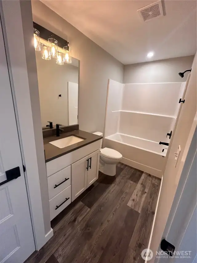Full guest bath with tub/shower combo and linen closet. Please note cabinet, countertops and flooring selection follow through the whole house. *previous build