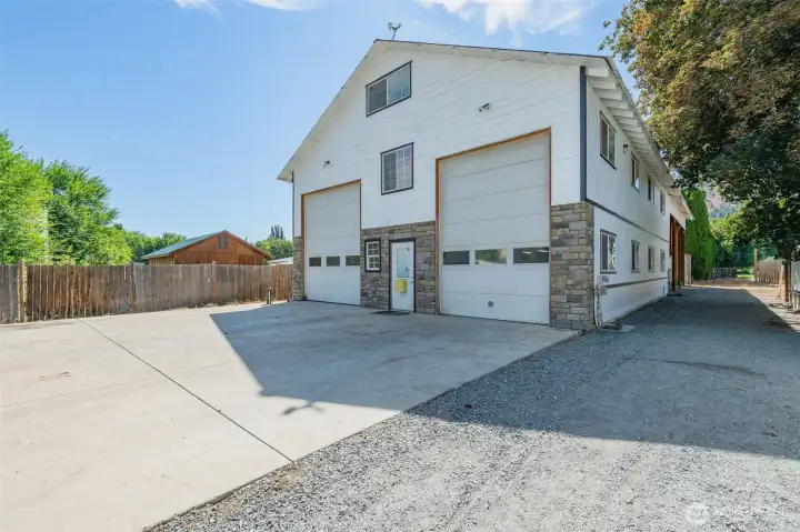 Shop Exterior. 48 ft. long x 36 ft. wide. 14 feet tall bay doors. And RV. hookups