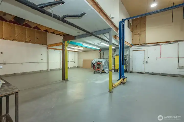 Right bay facing rear door and cleaning equipment.
