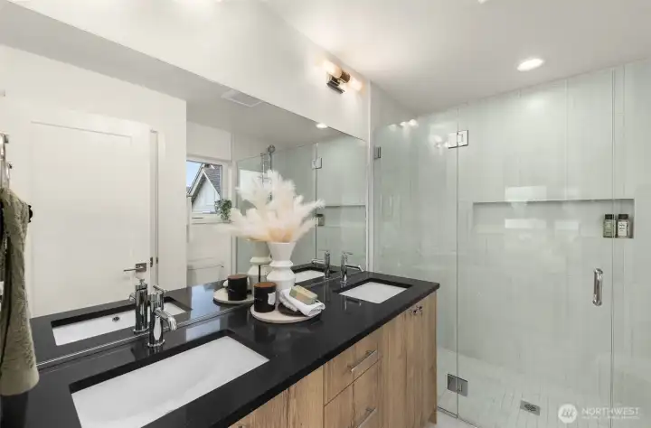 The primary bathroom is a true sanctuary — double vanity, sleek fixtures, and elegant finishes create a spa-like daily experience.