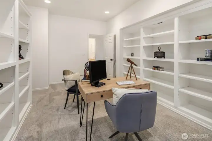 Lower level den with built in bookshelves. That's TWO home offices.