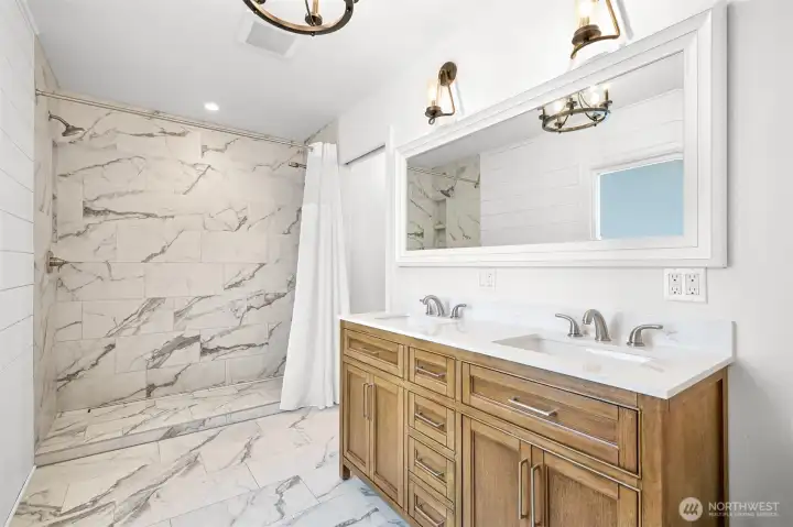 New primary suite bathroom with large shower and double vanity
