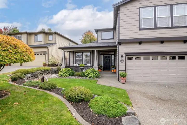 Custom curbing, mature, maintained garden beds & sprinkler system.