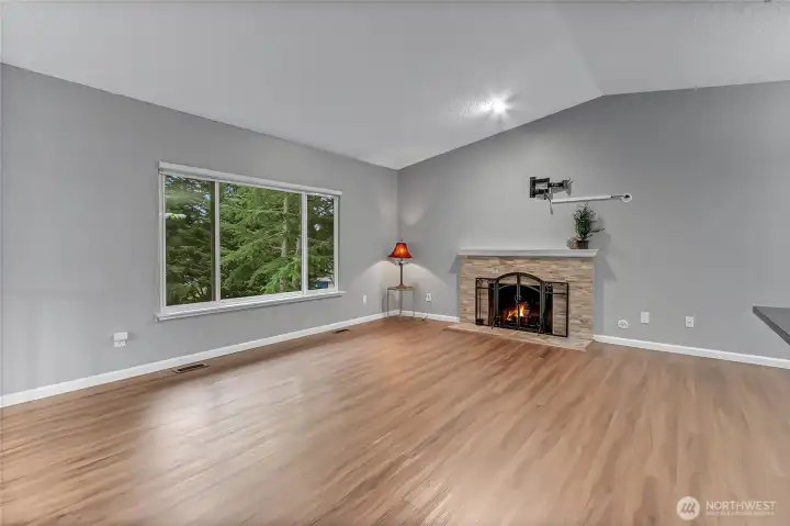 Upstairs open family room to kitchen and dining area.  Vaulted ceilings