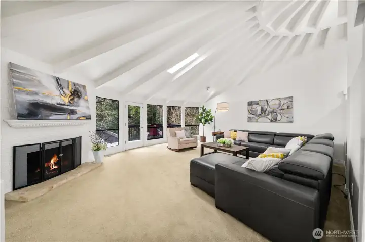 Ling room opens to an elevated deck overlooking a private backyard & tranquil greenbelt