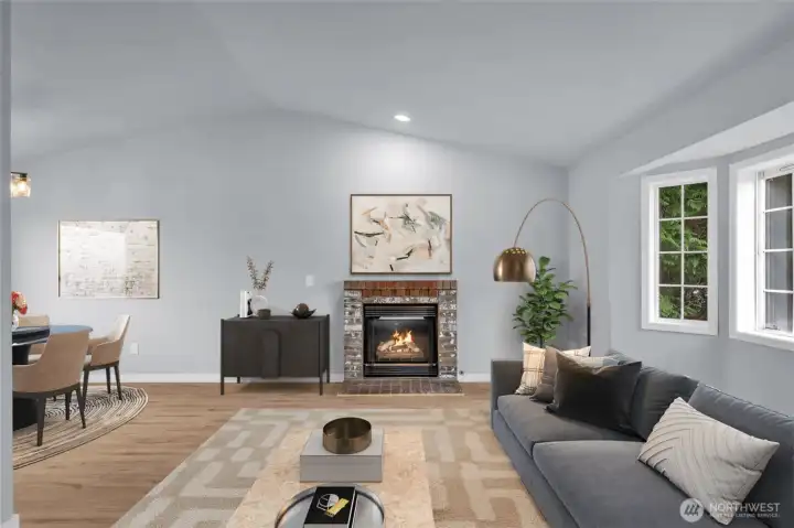 Photo stage living room. with gas fireplace vaulted ceilings and all new lighting throughout the home.