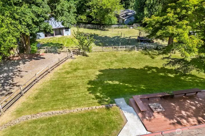 level lawn with pasture and barn. Long driveway to barn allows ample parking.