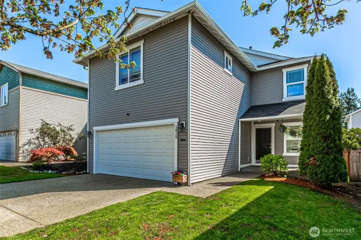 Two car garage with driveway parking.