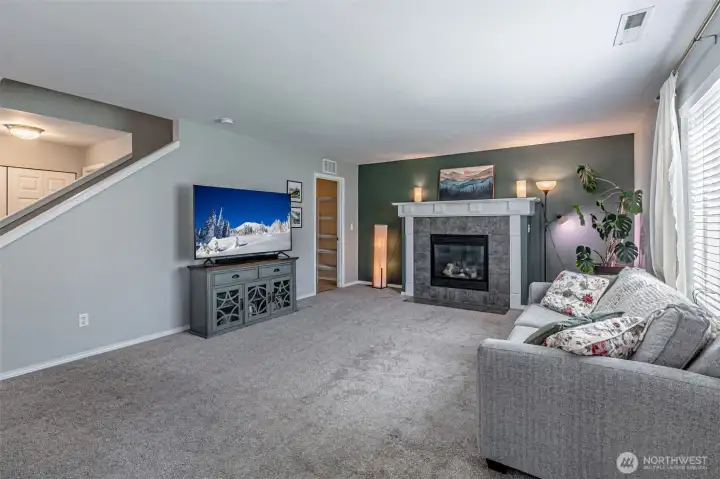 Great room seating area with fireplace.  Angled cutout on stairwell is nice for natural light transfer.