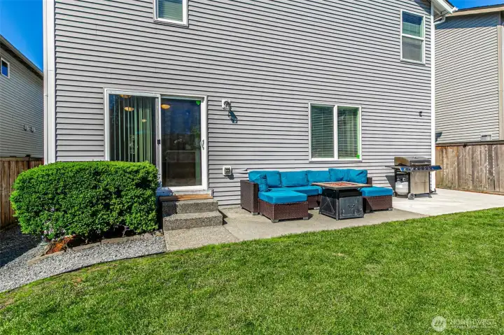 Sliding doors off the kitchen lead to the patio which spans the back yard.