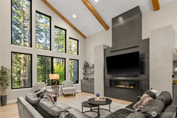 Great Room with custom fireplace and soaring windows
