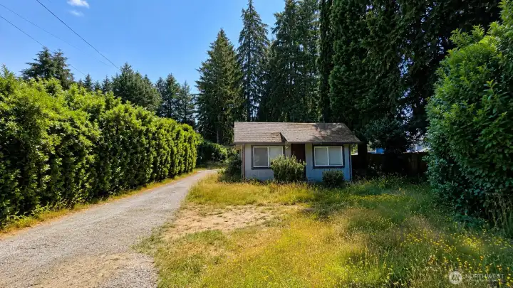 Rambler on a prime half-acre lot with endless potential.