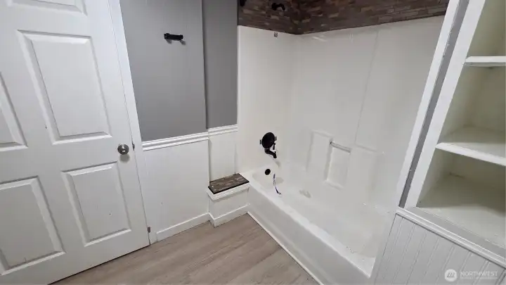 The main bath features a newly installed tub/shower, adding a fresh and updated feel to the space.