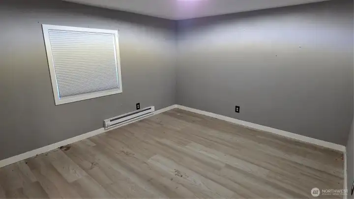 Newly installed LVP flooring enhances Bedroom #1 with durability and contemporary style.