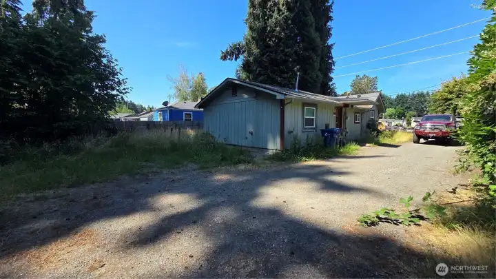 This generous half-acre lot provides ample parking and space for a variety of needs.