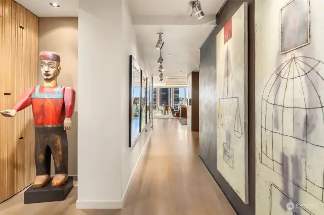 Gallery of walls is perfect for art collectors. Hardwood floors are clear straight grain white oak.