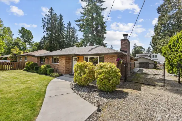 Warm inviting front of home with a deep driveway for RV parking