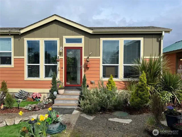 This five-year-old custom designed single wide manufactured home is located at the back of the property.