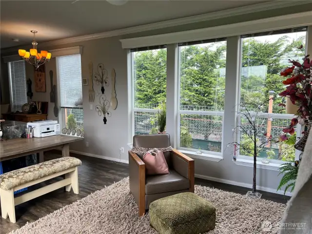 Large windows bring in lots of light into this comfortably sized living room.