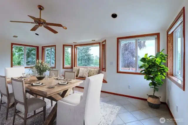 The dining/flex space allows plenty of room for entertaining with ceramic tile floors, a cozy bench seat and lots of wood wrapped windows for soaking in the view. *Room is virtually staged