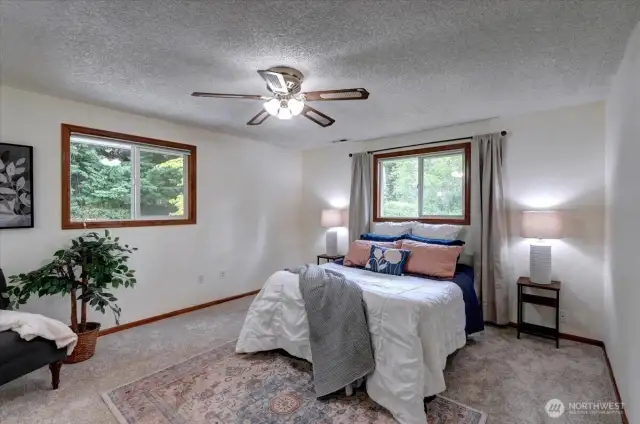 The spacious main level primary suite features an attached bath & roomy walk-in closet