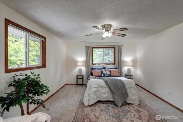 Privately situated & overlooking the lush back yard, there is a slider to a deck to the left of this photos where you can enjoy your morning coffee or favorite evening beverage