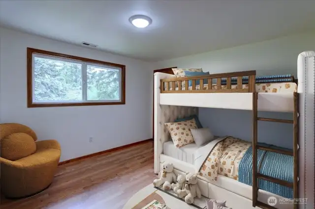 The main level bedroom offers laminate floors and a generous closet. *Room is virtually staged