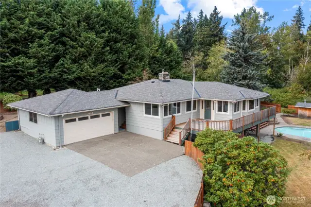 The oversized 2 car garage features a work bench & drop down attic storage.