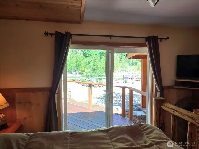 Sliding doors off of the primary bedroom lead to your wonderful backyard.
