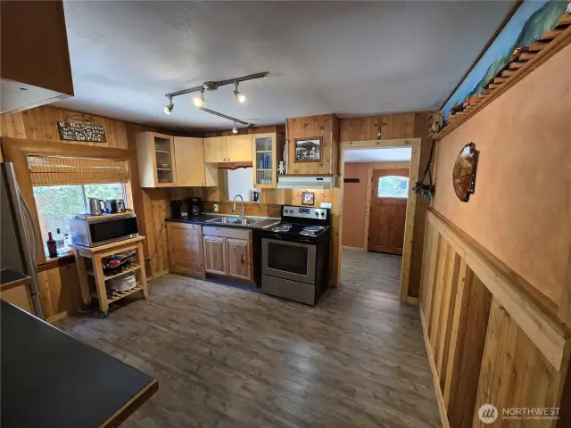 Spacious kitchen with nice flooring.