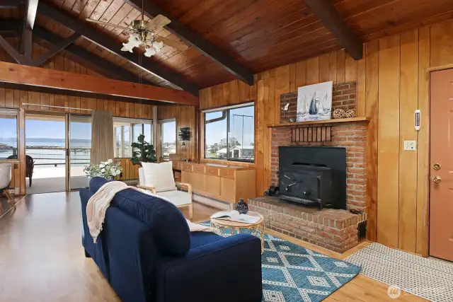 Vaulted ceilings and a wood bringing fireplace greet you as you come in the door.
