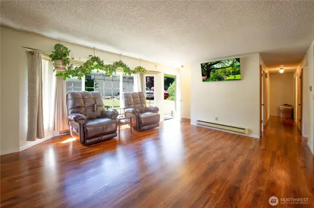 Large, bright living room with beautiful laminate hardwoods