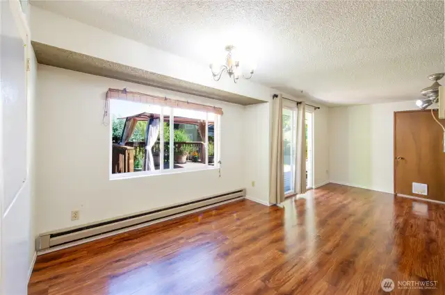Dining area with slider out to the fully fenced, level backyard & large deck.