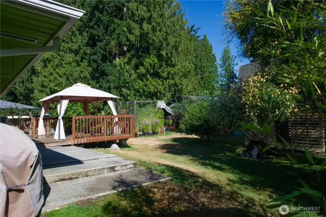 Huge, fully fenced, level backyard with 20' x 16' deck & gazebo, garden areas, shed/chicken/coop.