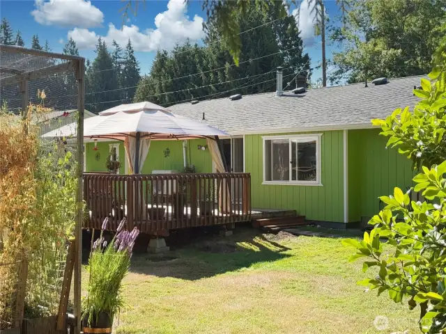 Huge, fully fenced, level backyard with 20' x 16' deck & gazebo, garden areas, shed/chicken/coop.